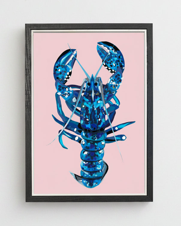 Framed artwork of a blue lobster on a pink background