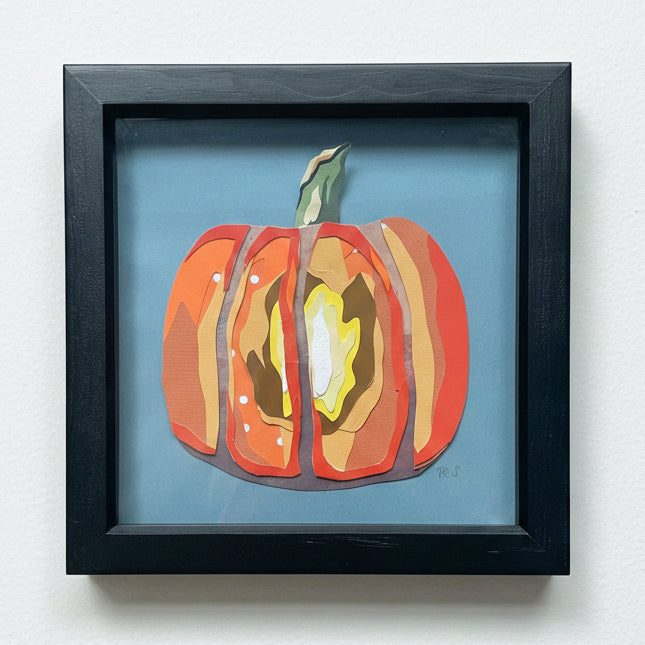 Colorful pumpkin art piece on a blue background with a black frame