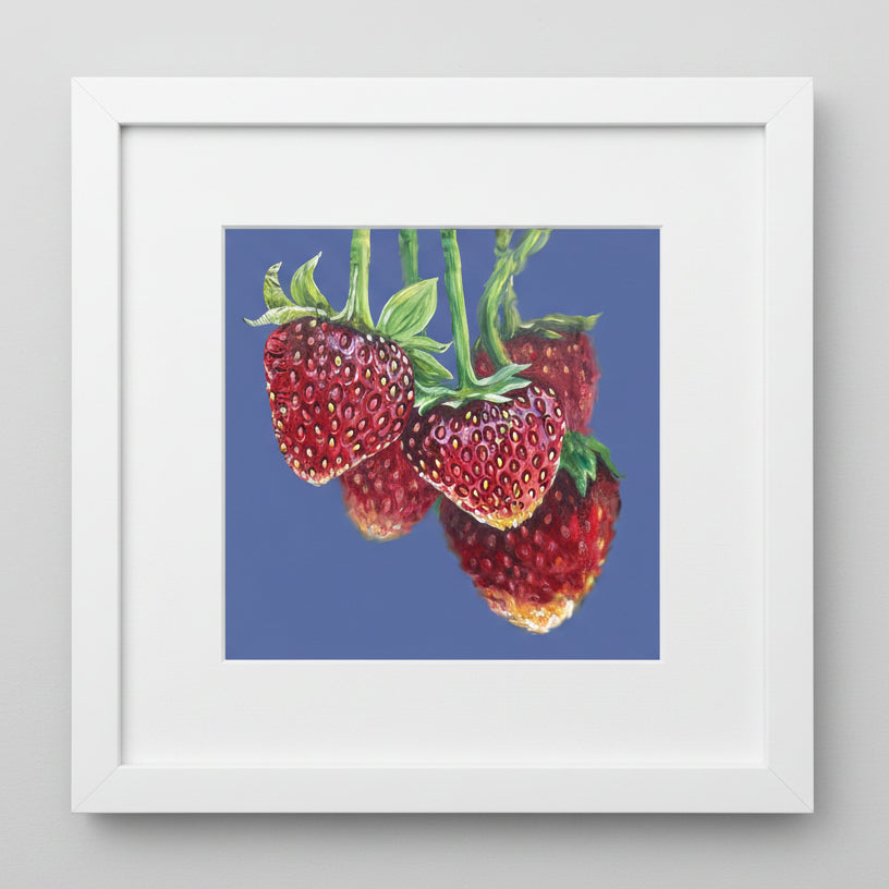 Framed artwork of strawberries on a blue background