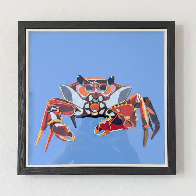 Framed artwork of a colourful crab on a blue background