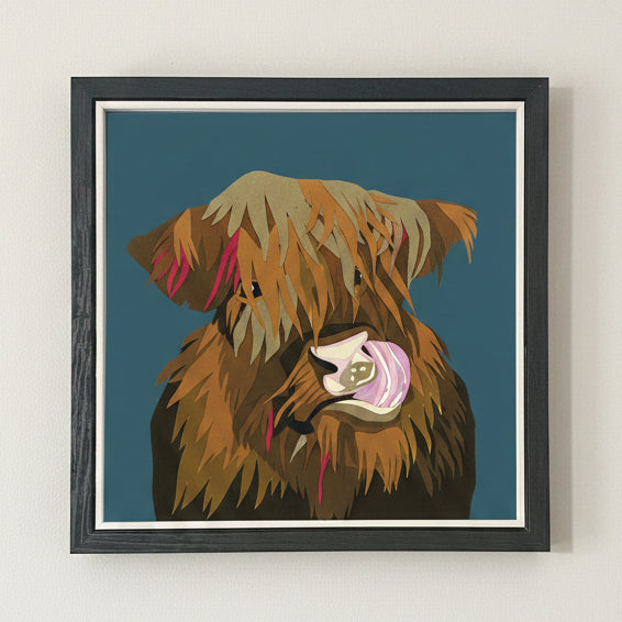 Framed highland cow on a teal background.