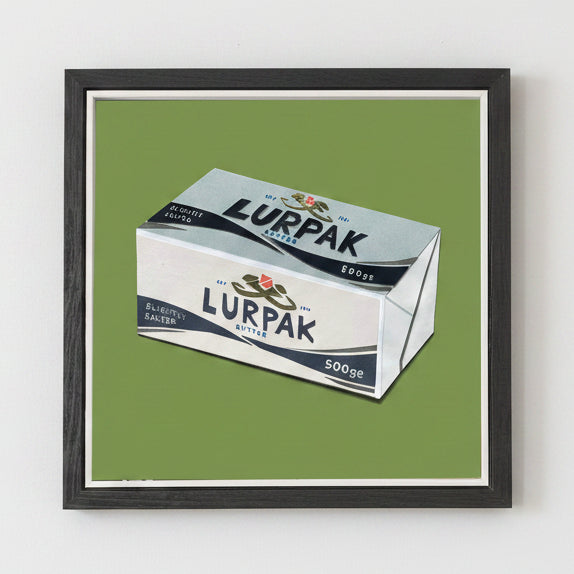 Framed artwork of Lurpak butter on a green background