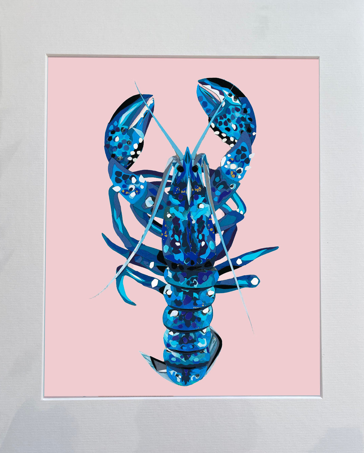 Mounted artwork of a blue lobster on a pink background