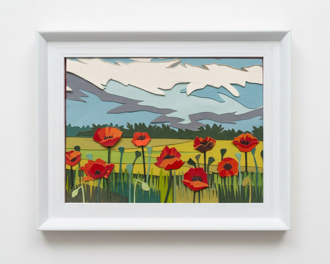 A framed art print depicting a stylized landscape with red poppies in a field.