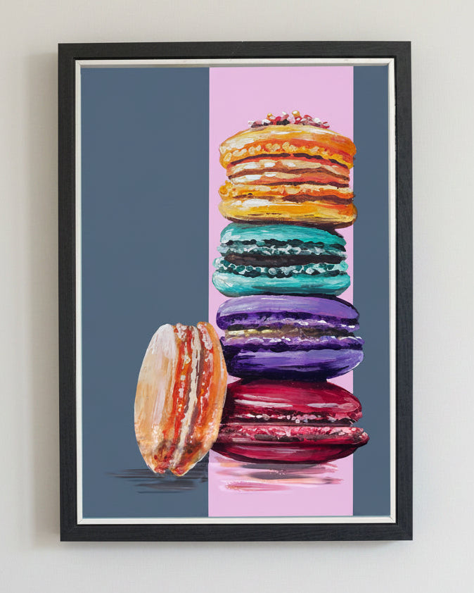 Framed artwork of colourful macarons on a striped background