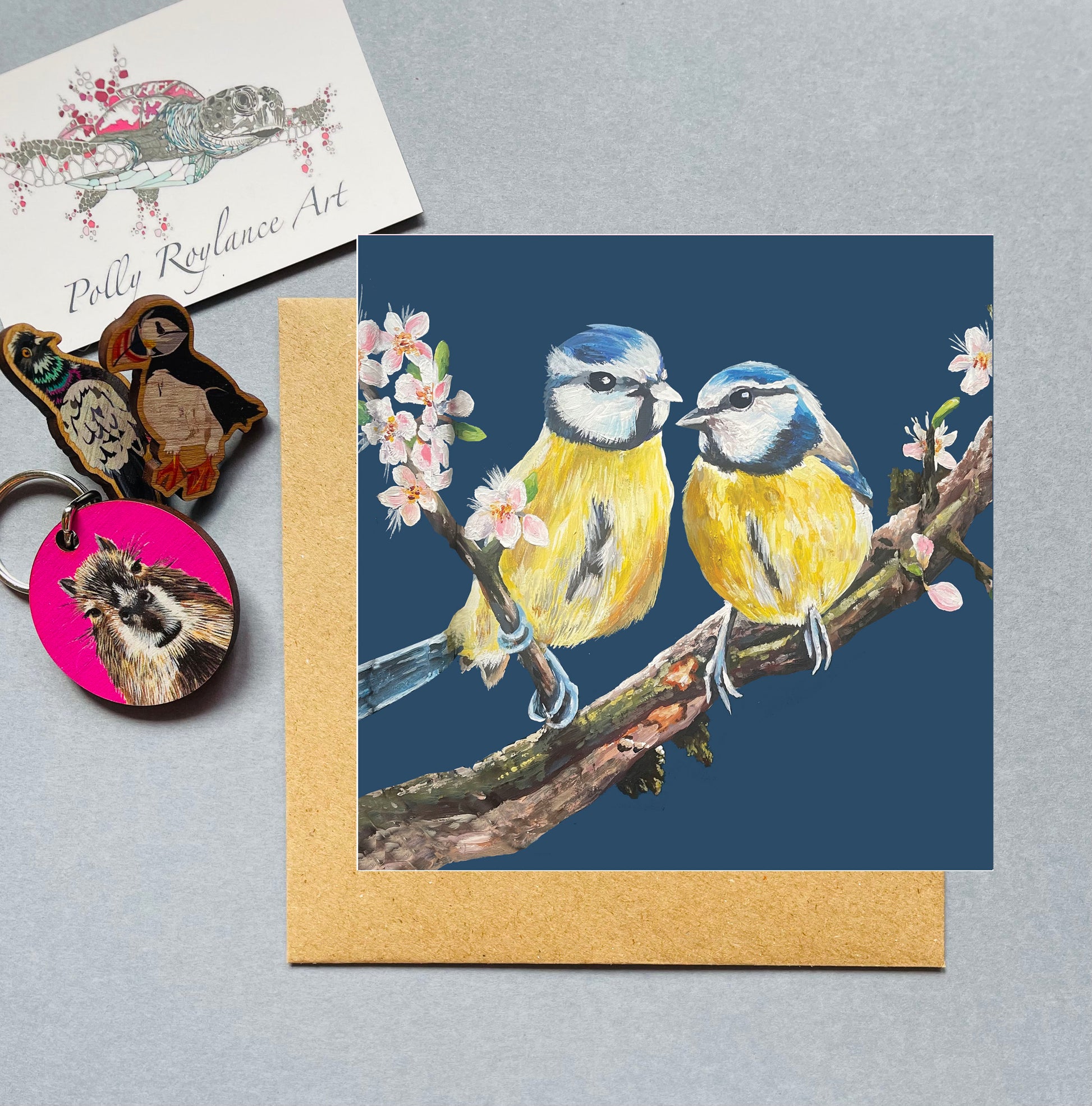 Greeting card with two blue tits on a branch, with blossom