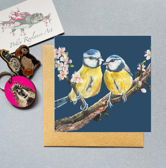 Greeting card with two blue tits on a branch, with blossom