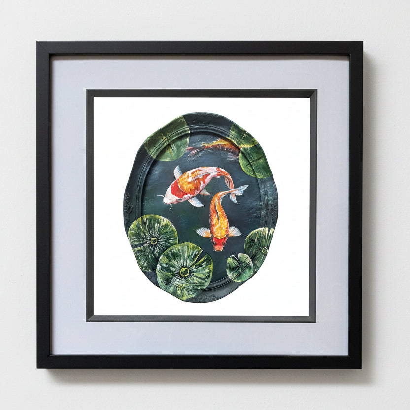 Framed wall art featuring a painted koi fish pond scene with two orange-and-white koi fish among green lily pads on a dark water background.