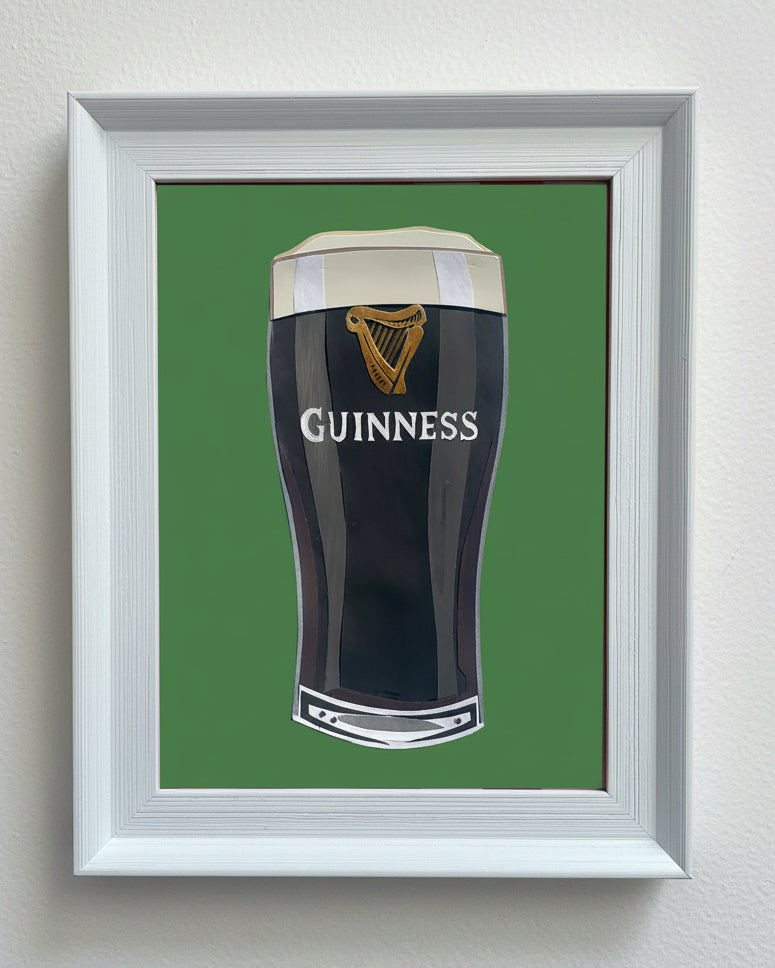 Framed artwork of a Guinness glass on a green background