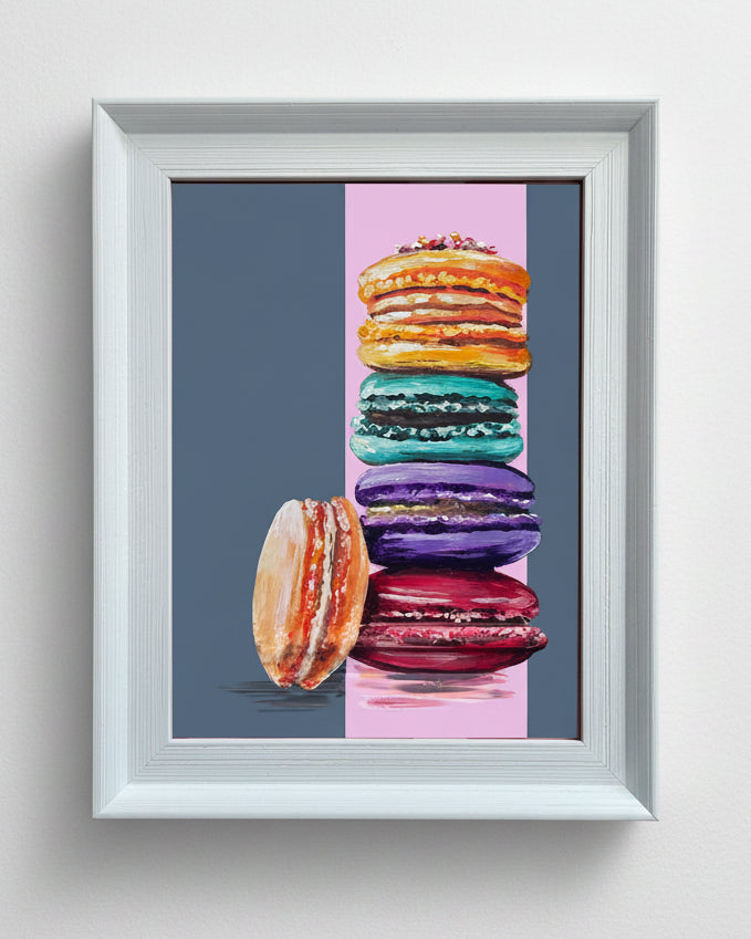 Framed artwork of colourful macarons.